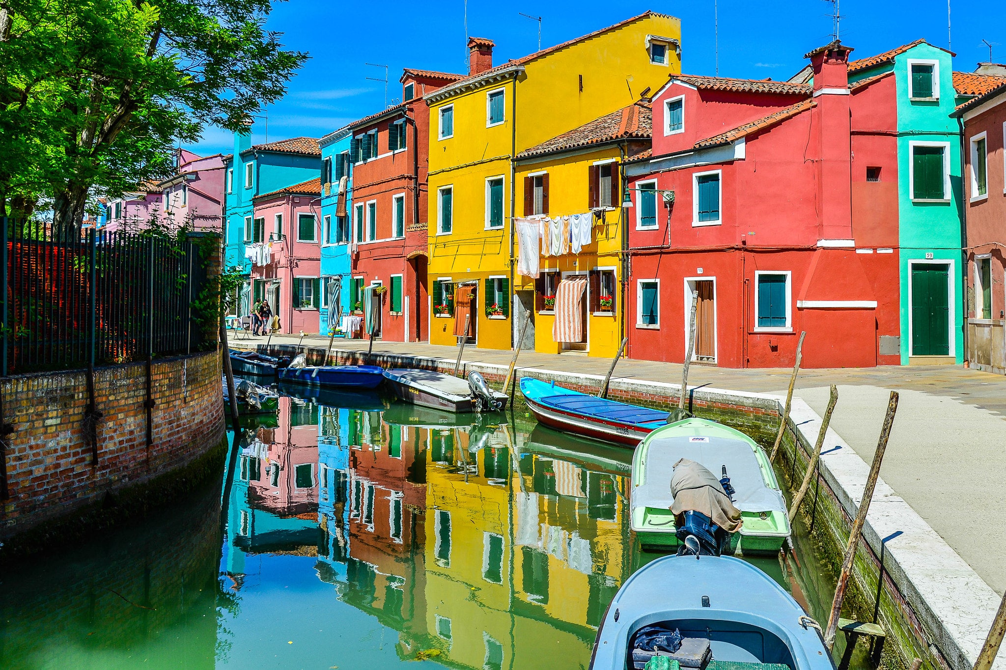 The vibrant, colorful houses of Burano reflecting on the canals