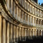 The iconic Royal Crescent in Bath, a stunning example of Georgian architecture inspired by Palladian principles, harmoniously blending with the surrounding landscape