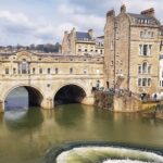 Pulteney Bridge in Bath, an elegant 18th-century masterpiece by architect Robert Adam, showcasing Palladian influence over the River Avon